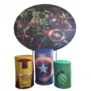 Superhero-themed party decoration set with round backdrop and colorful pedestal stands for kids birthday events